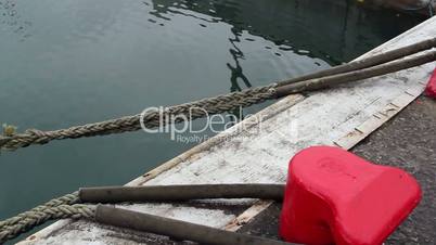 A rope tied on the ship on dock