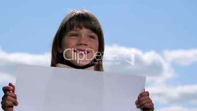 Boy holding a sheet of paper.Child holding a sheet of paper