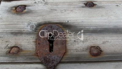 Rusty lock on the wooden shingle