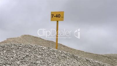 A signage on top a heap of rocks