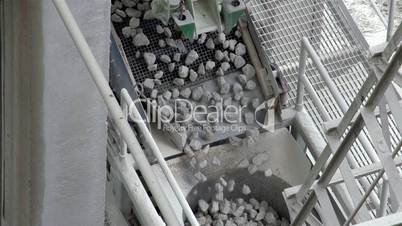 Rocks slowly dropping from a conveyor