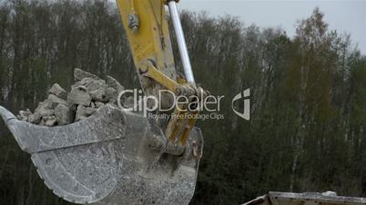 A backhoe s head with stones
