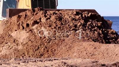 Brown soil being pushed by the bulldozer