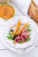 Ham with melon and olives