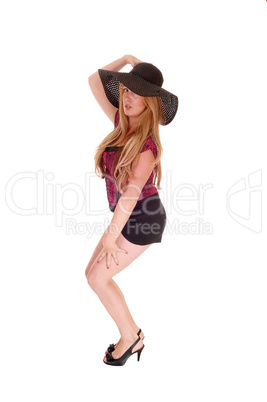 Woman in shorts and hat.