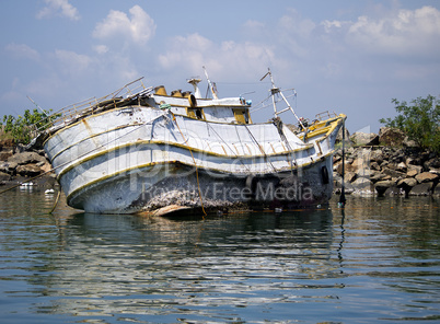 Rotten fisher boat at the beach in the morning light