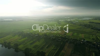 Village and fields with a bird's-eye view on sunset