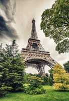 La Tour Eiffel in Paris surrounded by trees in summer