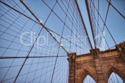 The Brooklyn Bridge at sunset. Upward view of Pylon and cables
