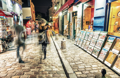 PARIS - JUNE 23, 2014: Tourists and locals walk in Montmartre st