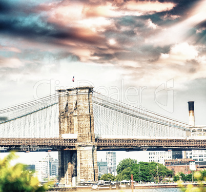 Brooklyn Bridge framed by trees on a beautiful summer day