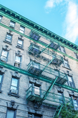 Classic New York Bowery building with green ladders for fire esc