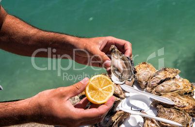 Man hands with lemon and oyster