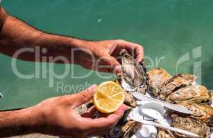 Man hands with lemon and oyster