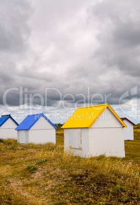 Colorful cabins along the sea. Beach huts along the ocean on a c