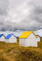 Colorful cabins along the sea. Beach huts along the ocean on a c