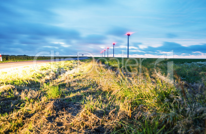 Industrial windmills at night. Blurred movement on a countryside