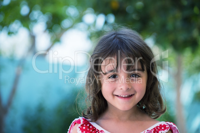 Happy baby girl with red dress smiling outdoor, trees and meadow Happy baby girl with red dress smiling outdoor, trees and meadow