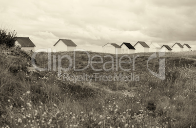 Colorful cabins along the sea. Beach huts along the ocean on a c