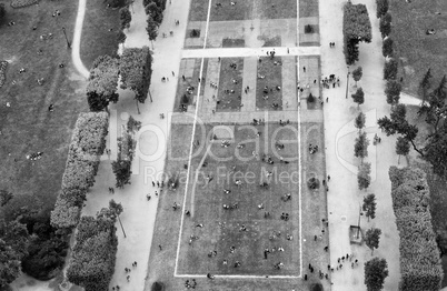 Crowd of tourists relaxing in Champs de Mars gardens, under the