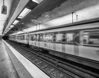 Paris subway station with speeding train blur, France