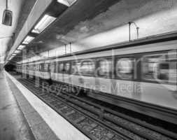 Paris subway station with speeding train blur, France