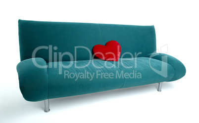 Green sofa with red heart shaped pillow