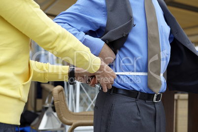 Personal trainer measuring a businessman