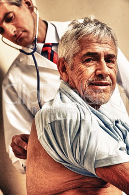 Male doctor examining elder patient at the hospital