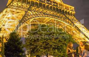 PARIS - JULY 7, 2014: Tourists enjoy night view of Eiffel Tower.