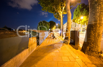 Paris with closed stalls along the river Seine at night