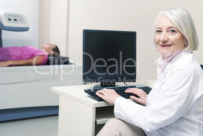 Senior female doctor analyzing results of woman patient at bone