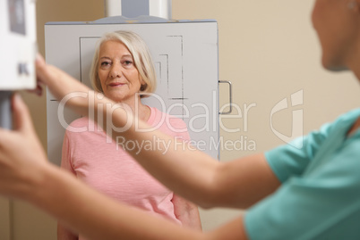 Female patient ready to be screened at X-Ray machine