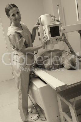 Smiling female doctor scanning male patient with x-ray machine