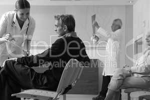 Happy female doctor showing medical results to man in 40s with d