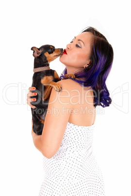 Woman kissing her dog.