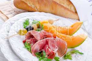 Ham with melon and olives