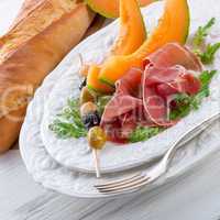 Ham with melon and olives