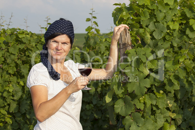 Woman in vineyard holding wine glass