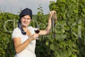 Woman in vineyard holding wine glass