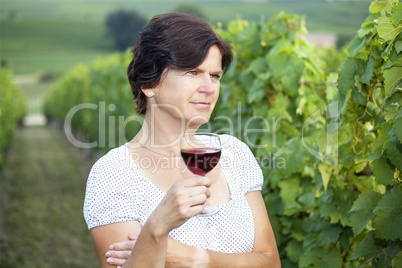 Woman in vineyard holding wine glass