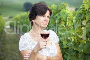 Woman in vineyard holding wine glass
