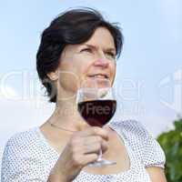 Woman in vineyard holding wine glass