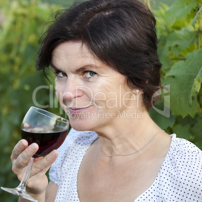 Woman in vineyard holding wine glass