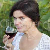 Woman in vineyard holding wine glass