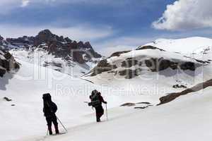 Two hikers in snowy mountains