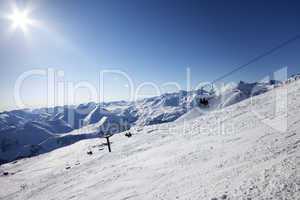 Ski slope and blue sky with sun