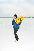 Woman running with package in the winter landscape