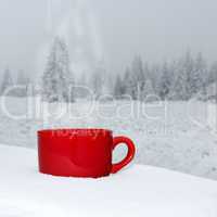 Cup is on the table in winter landscape