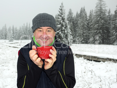 Man warms up a hot drink in the cup